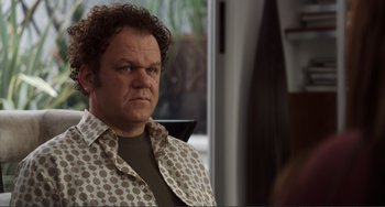 Movie still from “Cyrus” (2010), directed by Jay Duplass – A person with curly hair wearing a shirt; Close Up shot, Over the shoulder angle