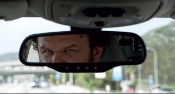 Movie still from “Cyrus” (2010), directed by Jay Duplass – A man's face in the rear view mirror of a car; Extreme Close Up shot, Over the shoulder angle