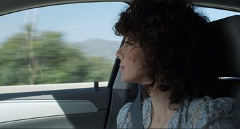 Movie still from “Cyrus” (2010), directed by Jay Duplass – A woman sitting in the passenger seat of a car looking out the window; Close Up shot, Over the shoulder angle