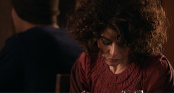 Movie still from “Cyrus” (2010), directed by Jay Duplass – A person with curly hair looking down; Close Up shot, High angle