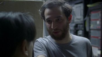 A man with a beard talking to a woman