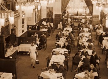Movie still from “Daisies” (1966), directed by Vera Chytilová – An old photo of people sitting at tables in a restaurant; Wide shot, High angle