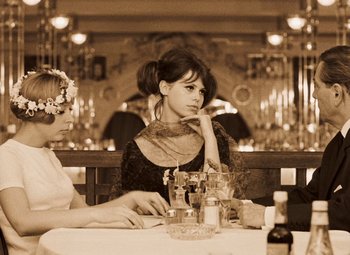 Movie still from “Daisies” (1966), directed by Vera Chytilová – Two women sitting at a table in front of candles; Medium shot, High angle