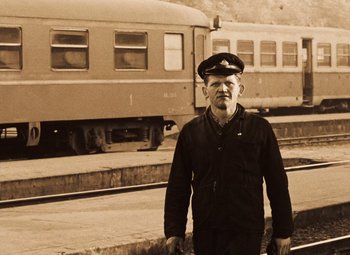 Movie still from “Daisies” (1966), directed by Vera Chytilová – An older man standing in front of a train; Medium shot, Low angle