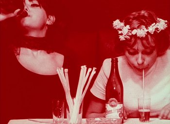 Movie still from “Daisies” (1966), directed by Vera Chytilová – Two women sitting at a table with drinks and straws; Close Up shot, Low angle