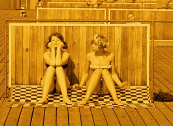Movie still from “Daisies” (1966), directed by Vera Chytilová – Two young girls sitting in a wooden room; Wide shot, High angle