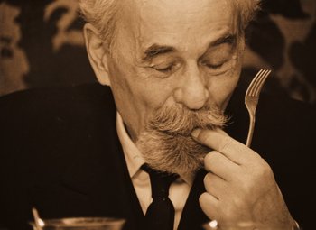 Movie still from “Daisies” (1966), directed by Vera Chytilová – An old man with a beard and a fork in his mouth; Close Up shot, High angle