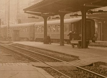 Movie still from “Daisies” (1966), directed by Vera Chytilová – An old photo of a man sitting on a bench at a train station; Extreme Wide shot, High angle