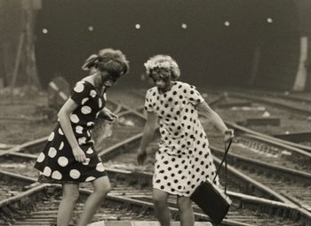 Movie still from “Daisies” (1966), directed by Vera Chytilová – Two young women walking on train tracks holding luggage; Wide shot, High angle