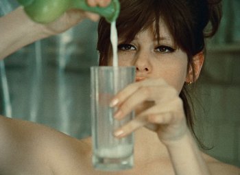 Movie still from “Daisies” (1966), directed by Vera Chytilová – A woman is pouring a drink into a glass; Extreme Close Up shot, Over the shoulder angle
