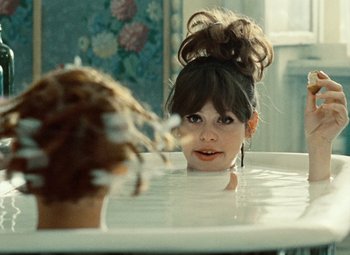 Movie still from “Daisies” (1966), directed by Vera Chytilová – A woman in a bath tub looking into the camera; Close Up shot, Over the shoulder angle