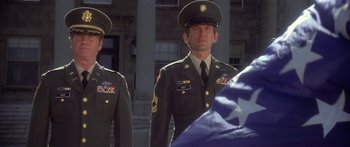 Movie still from “Damien: Omen II” (1978), directed by Mike Hodges – Two men in military uniforms standing in front of a building; Medium shot, Low angle