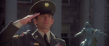 Movie still from “Damien: Omen II” (1978), directed by Mike Hodges – A soldier saluting in front of a building; Close Up shot, Low angle