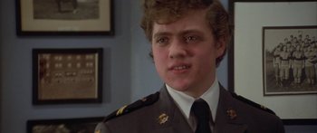 Movie still from “Damien: Omen II” (1978), directed by Mike Hodges – A man in a uniform is looking at the camera; Close Up shot, Low angle