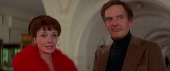 Movie still from “Damien: Omen II” (1978), directed by Mike Hodges – A man and a woman standing next to each other; Close Up shot, Low angle