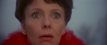 Movie still from “Damien: Omen II” (1978), directed by Mike Hodges – A woman's eyes and face; Close Up shot, Low angle