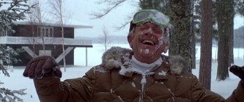 Movie still from “Damien: Omen II” (1978), directed by Mike Hodges – A man in a brown jacket with snow on his face; Medium shot, Low angle