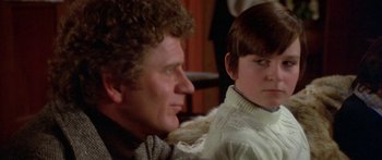 Movie still from “Damien: Omen II” (1978), directed by Mike Hodges – A man and a boy sitting next to each other; Close Up shot, Over the shoulder angle