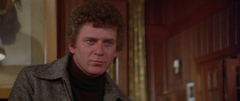 Movie still from “Damien: Omen II” (1978), directed by Mike Hodges – A person wearing a sweater; Close Up shot, Low angle