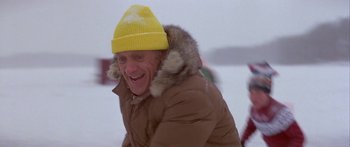 Movie still from “Damien: Omen II” (1978), directed by Mike Hodges – An older man wearing a yellow hat and a brown jacket; Medium shot, Low angle