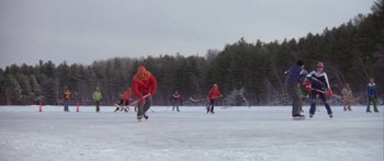 Movie still from “Damien: Omen II” (1978), directed by Mike Hodges – A group of men playing a game of ice hockey on a frozen lake; Extreme Wide shot, High angle