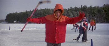 Movie still from “Damien: Omen II” (1978), directed by Mike Hodges – A man in a red and orange jacket holding a stick; Medium shot, Low angle