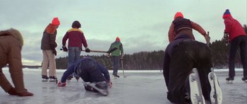 Movie still from “Damien: Omen II” (1978), directed by Mike Hodges – A group of people playing a game of hockey on a frozen lake; Wide shot, High angle