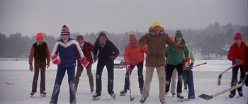 Movie still from “Damien: Omen II” (1978), directed by Mike Hodges – A group of people standing on top of a snow covered ground; Wide shot, Low angle