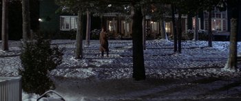 Movie still from “Damien: Omen II” (1978), directed by Mike Hodges – A man standing in the snow next to a tree; Extreme Wide shot, High angle