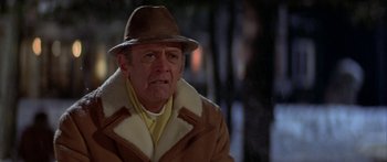 Movie still from “Damien: Omen II” (1978), directed by Mike Hodges – An older man wearing a hat and a coat; Close Up shot, Low angle