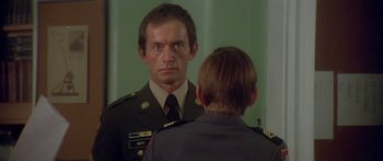 Movie still from “Damien: Omen II” (1978), directed by Mike Hodges – A man in a military uniform looking at himself in the mirror; Close Up shot, Over the shoulder angle