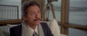 Movie still from “Damien: Omen II” (1978), directed by Mike Hodges – A person wearing a suit and tie; Close Up shot, Over the shoulder angle