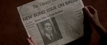 Movie still from “Damien: Omen II” (1978), directed by Mike Hodges – An old newspaper with an image of a man on it; Extreme Close Up shot, High angle