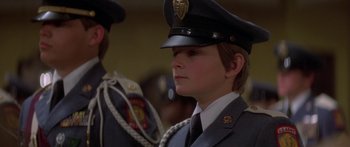 Movie still from “Damien: Omen II” (1978), directed by Mike Hodges – A woman in a uniform is standing next to a man in a uniform; Close Up shot, Low angle