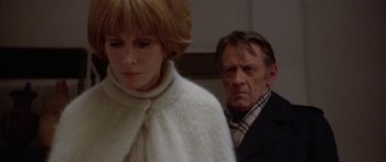 Movie still from “Damien: Omen II” (1978), directed by Mike Hodges – A man and a woman standing next to each other; Close Up shot, Over the shoulder angle