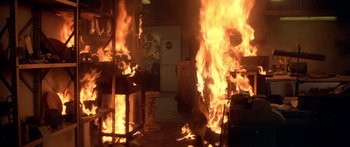 Movie still from “Damien: Omen II” (1978), directed by Mike Hodges – A room that has a lot of fire in it; Wide shot, High angle