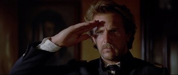 Movie still from “Dances with Wolves” (1990), directed by Kevin Costner – A man saluting with his hand up to his forehead; Close Up shot, Low angle