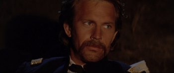 Movie still from “Dances with Wolves” (1990), directed by Kevin Costner – A person wearing a suit and tie; Close Up shot, Low angle