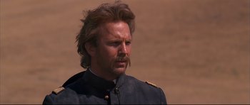 Movie still from “Dances with Wolves” (1990), directed by Kevin Costner – A person wearing a uniform; Close Up shot, Over the shoulder angle