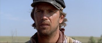 Movie still from “Dances with Wolves” (1990), directed by Kevin Costner – A person wearing a hat; Close Up shot, Low angle