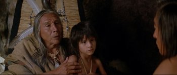 Movie still from “Dances with Wolves” (1990), directed by Kevin Costner – An older woman and a young girl sitting next to each other; Close Up shot, Low angle