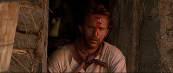 Movie still from “Dances with Wolves” (1990), directed by Kevin Costner – A person with a bandage on his head; Close Up shot, Over the shoulder angle