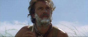 Movie still from “Dances with Wolves” (1990), directed by Kevin Costner – A person with a shaving brush on his face; Close Up shot, Low angle
