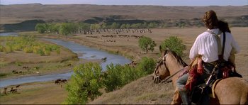 Movie still from “Dances with Wolves” (1990), directed by Kevin Costner – A herd of cattle grazing on a dry grass covered field; Extreme Wide shot, High angle