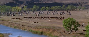Movie still from “Dances with Wolves” (1990), directed by Kevin Costner – A herd of wild horses grazing on a dry grass field; Extreme Wide shot, High angle
