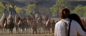 Movie still from “Dances with Wolves” (1990), directed by Kevin Costner – A group of native americans on horses in a field; Wide shot, Over the shoulder angle