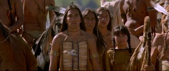 Movie still from “Dances with Wolves” (1990), directed by Kevin Costner – A group of native american men standing next to each other; Medium shot, Low angle