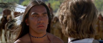 Movie still from “Dances with Wolves” (1990), directed by Kevin Costner – A person wearing a necklace; Close Up shot, Over the shoulder angle