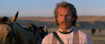 Movie still from “Dances with Wolves” (1990), directed by Kevin Costner – A person wearing a shirt; Close Up shot, Low angle