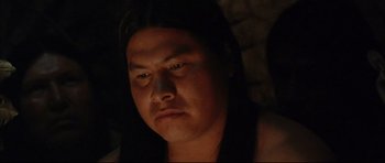 Movie still from “Dances with Wolves” (1990), directed by Kevin Costner – A man with long black hair is looking at the camera; Close Up shot, Low angle